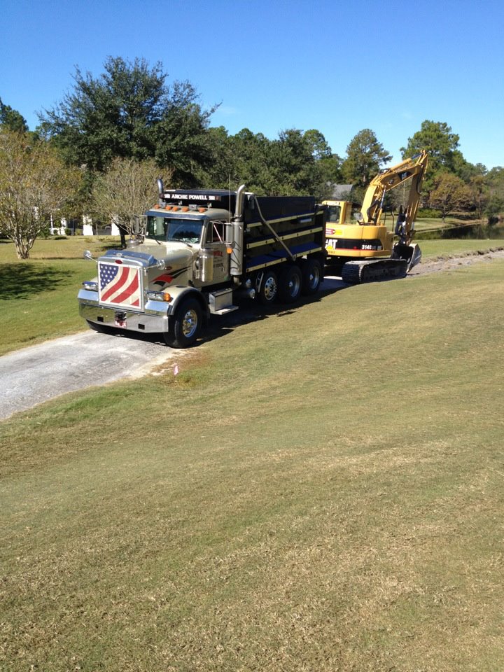 Dump truck with excavator for land clearing