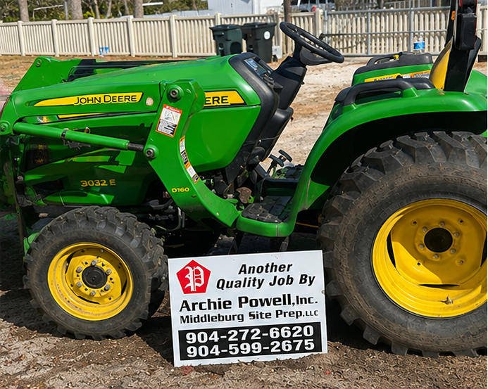 Archie Powell Inc. tractor with job sign after completed site preparation work